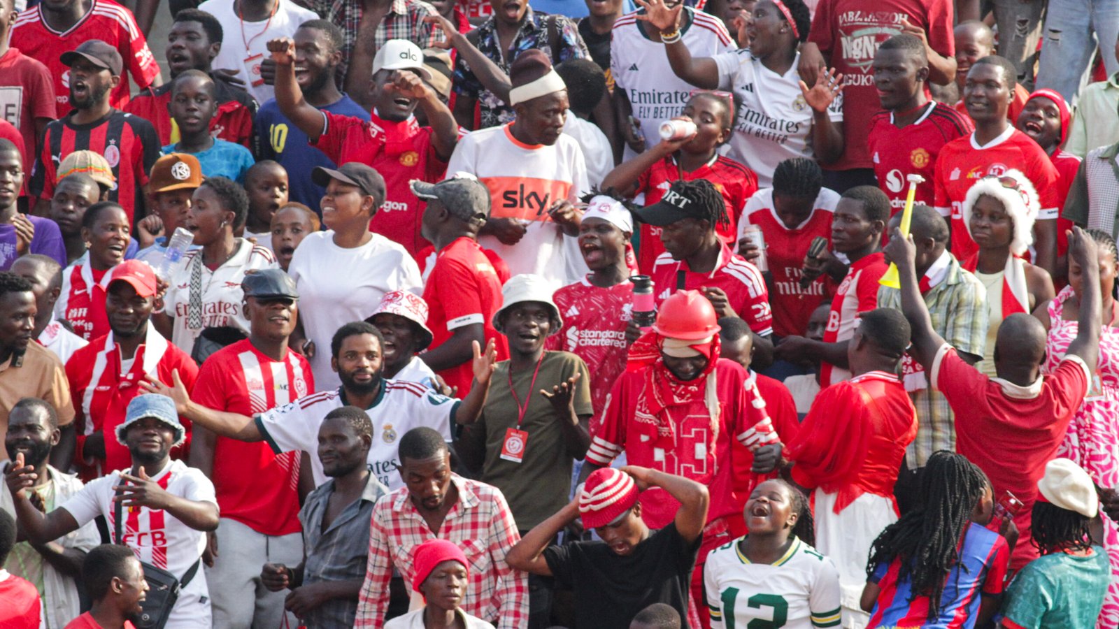FCB Nyasa Big Bullets supporters cheering and celebrating in the stands at Mpira Stadium.
