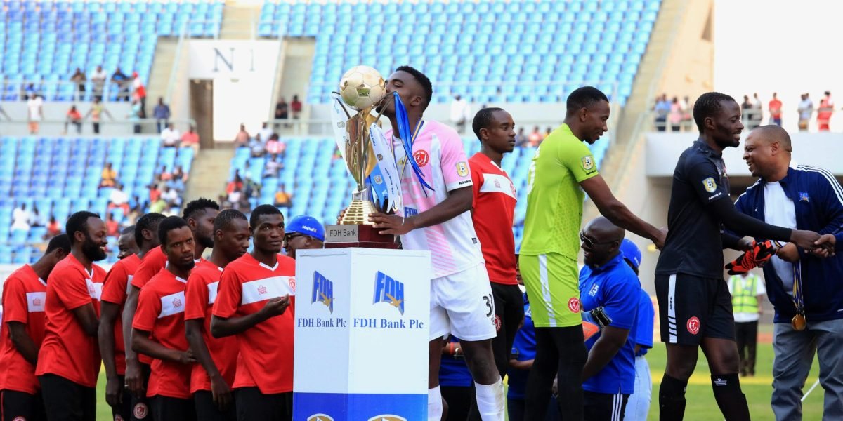 Ephraim Kondowe kissing the FDH Bank Cup. He scored FCB Nyasa Big Bullets' third goal against Mafco to win 3-0 in the final