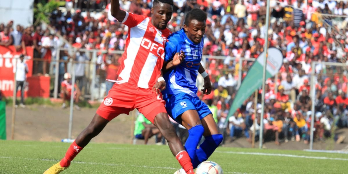 FCB Nyasa Big Bullets' Precious Phiri in action against Mighty Mukuru Wanderers midfielder Wisdom Mpinganjira in the TNM Super League