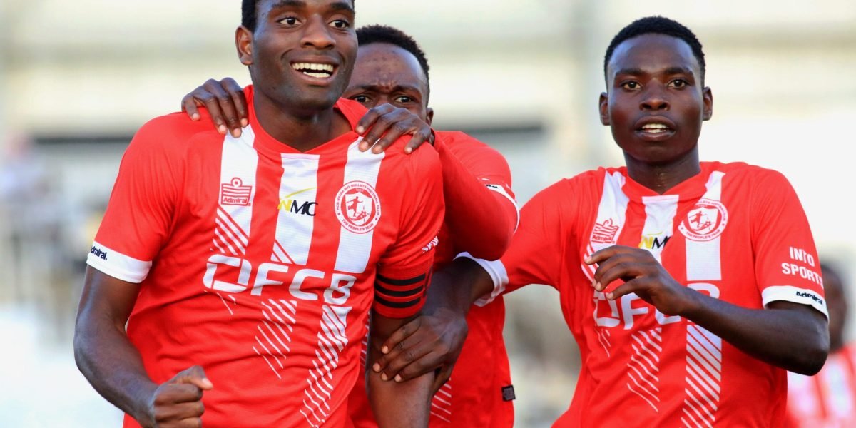 FCB Nyasa Big Bullets Reserves captain Oscar Petro celebrating his lone goal against Ntaja Rangers alongside Wongani Kaponya and Francis Malikebu