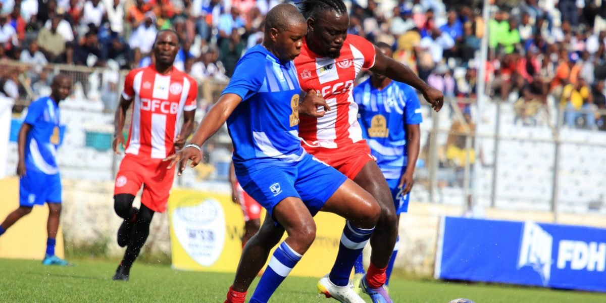 FCB Nyasa Big Bullets and Mighty Wanderers veterans James Sangala and Sankhani Nyirenda fight for the ball during the Legends Cup match at Kamuzu Stadium