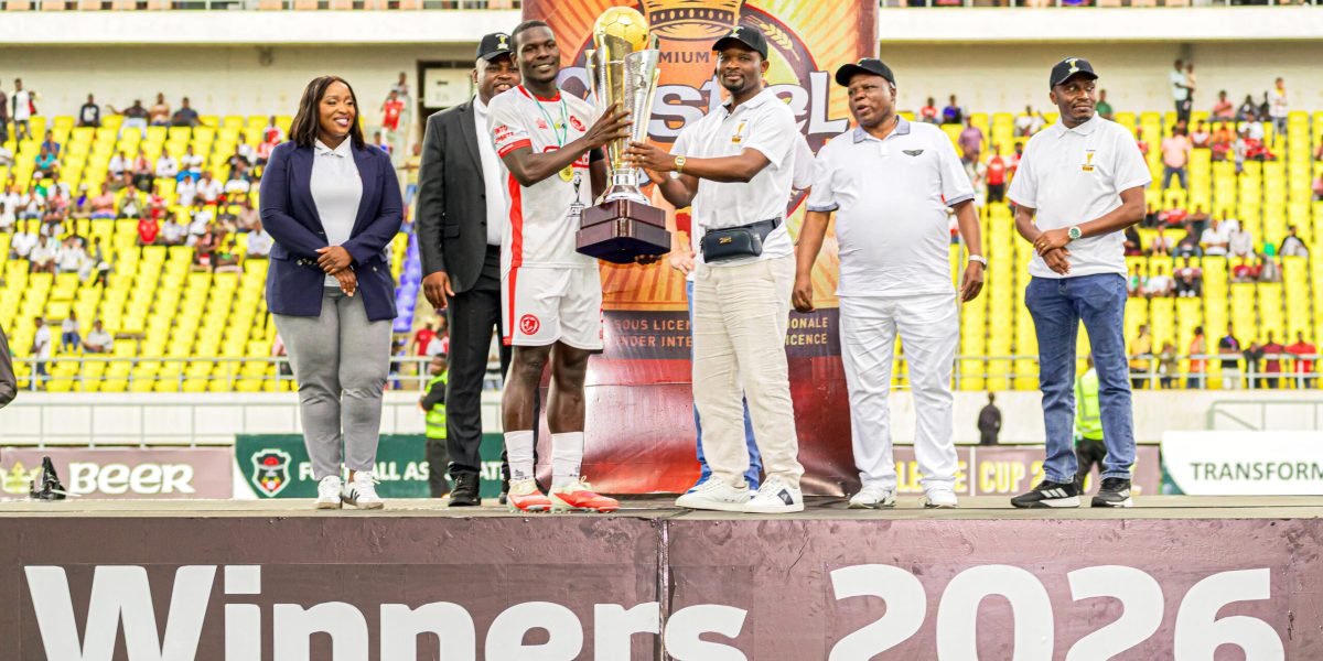 FCB Nyasa Big Bullets captain Frank Willard receives the Castel Challenge Cup from the Minister of Sports Alfred Gangata
