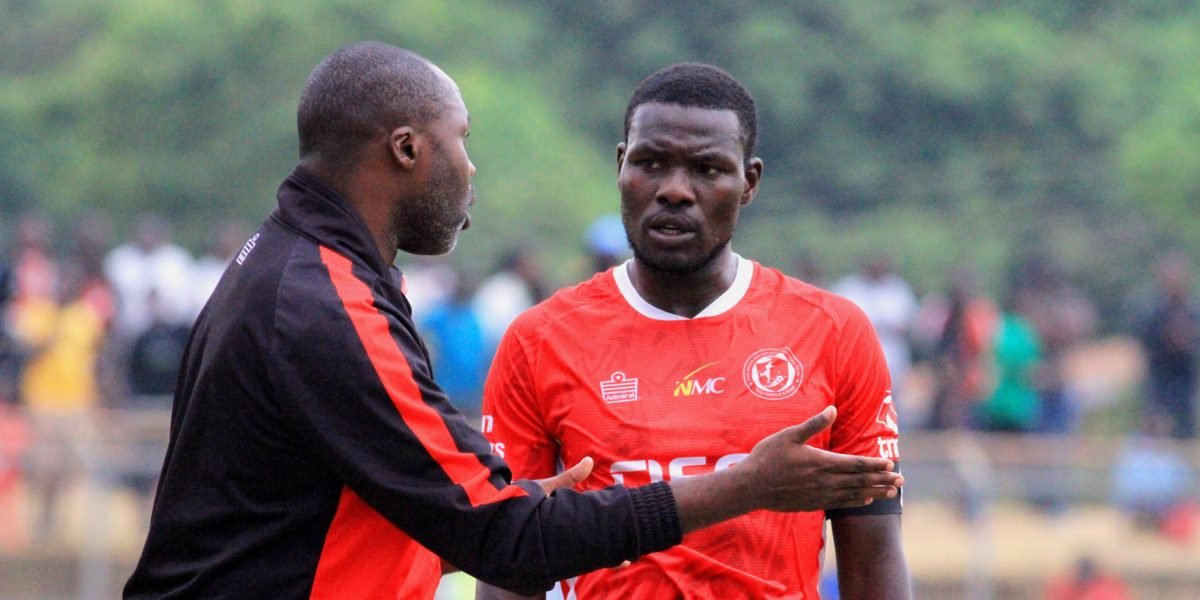 FCB Nyasa Big Bullets head coach Peter Mponda giving instructions to his captain Frank Willard during the 0-0 draw against Blue Eagles