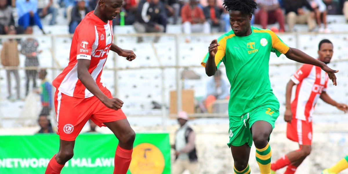 FCB Nyasa Big Bullets midfielder Blessings Mpokera and Civil Service United's Llyod Aaron in a TNM Super League encounter at Kamuzu Stadium