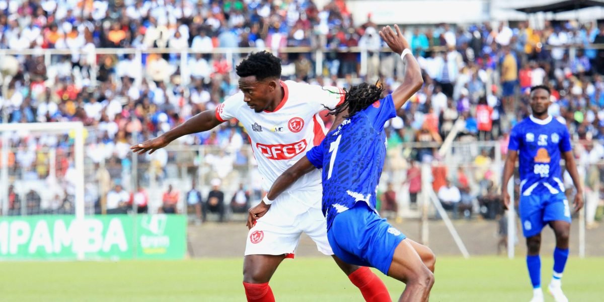 FCB Nyasa Big Bullets midfielder Chikumbutso Salima battles against Mighty Wanderers' Wisdom Mpinganjira