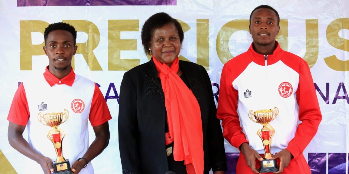FCB Nyasa Big Bullets midfielders Patrick Mwaungulu and Chawanangwa Gumbo pose with Precious Medical International CEO Dr Gertrude Mateyo
