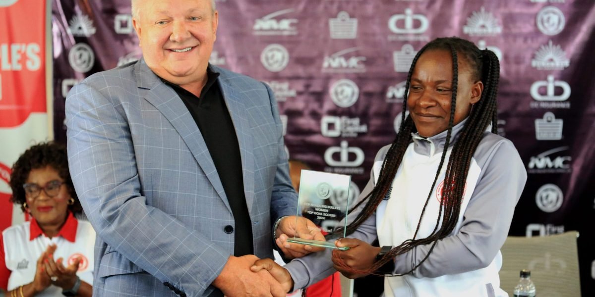 FCB Nyasa Big Bullets president Konrad Buckle presenting the Top Scorer's award to midfielder Tendai Sani who scored 65 league goals