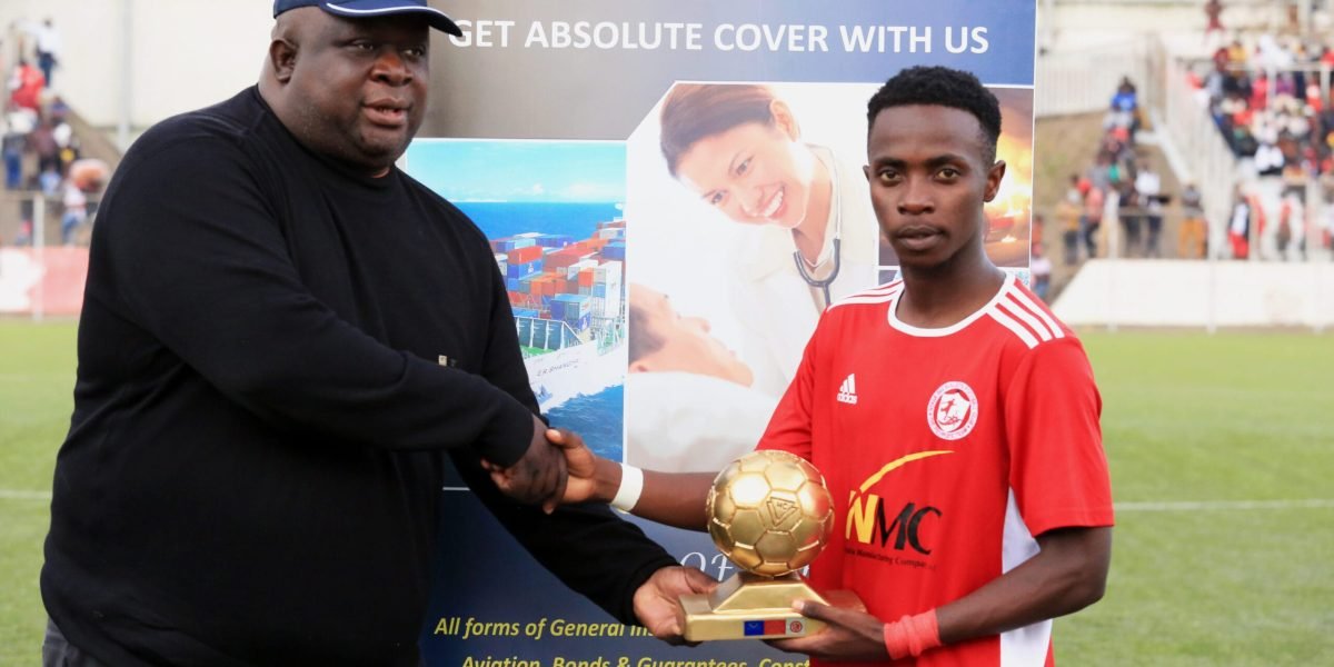 Hubertus Clausius Finance Director presenting the June Player of the Month award to Nyasa Big Bullets midfielder Patrick Mwaungulu