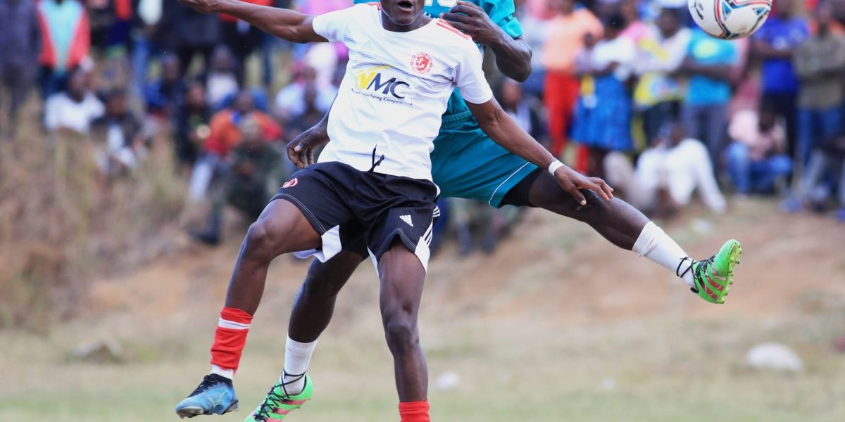 Nyasa Big Bullets Reserves forward Wongani Kaponya tussles against Changalume Barracks defender