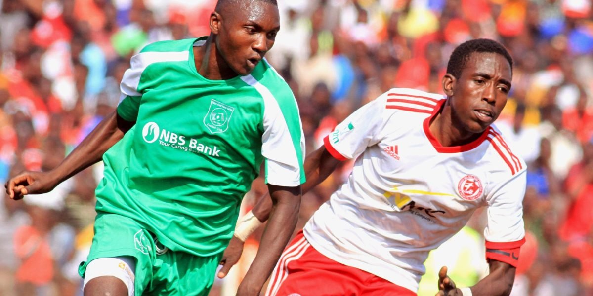 Nyasa Big Bullets defender Precious Sambani battles for the ball against Mafco FC goal scorer Zikani Sichinga