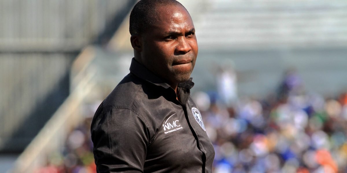 Peter Mponda watches from the technical area during the clash against Wanderers